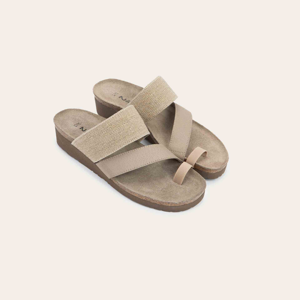 Pair of beige, multi-strap, sling-back sandals with a cork footbed.