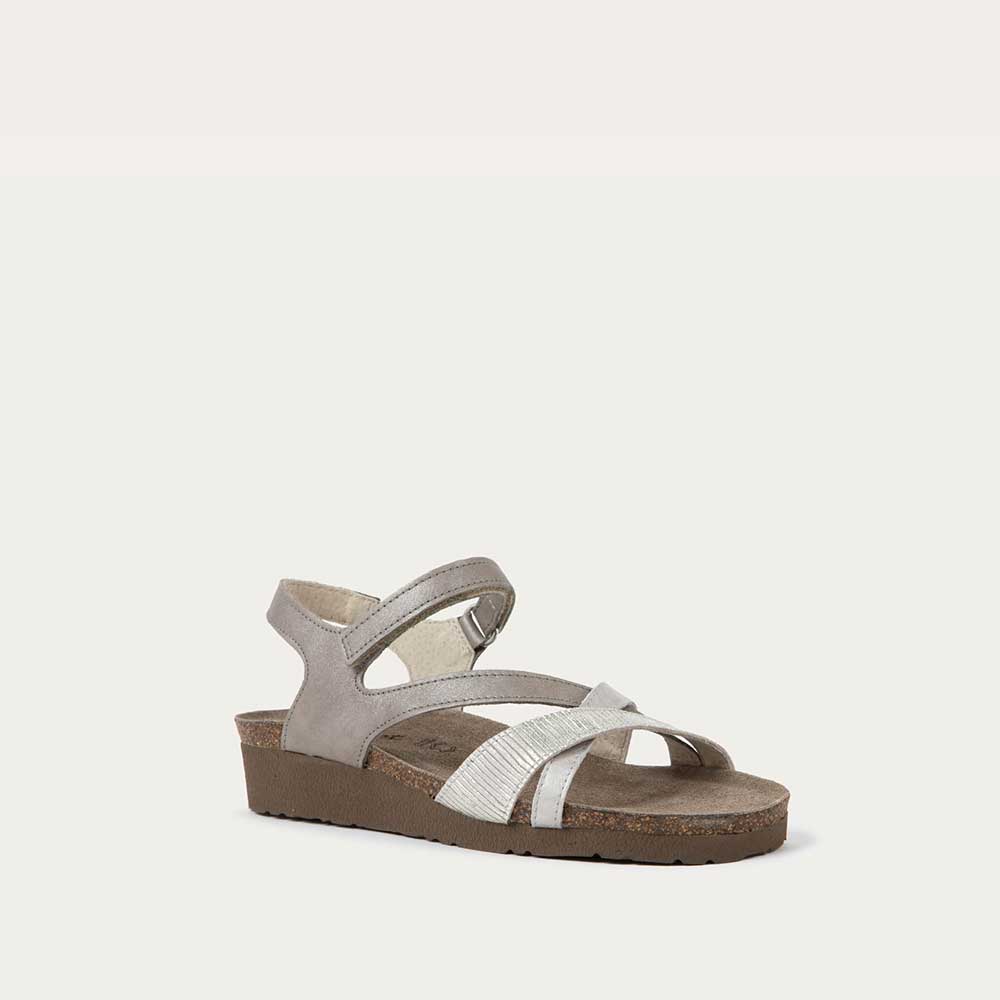 Angled profile view of a gray open-toe sandal with a cork wedge sole. Features leather and suede straps crossing over the front and a back strap with Velcro closure. 