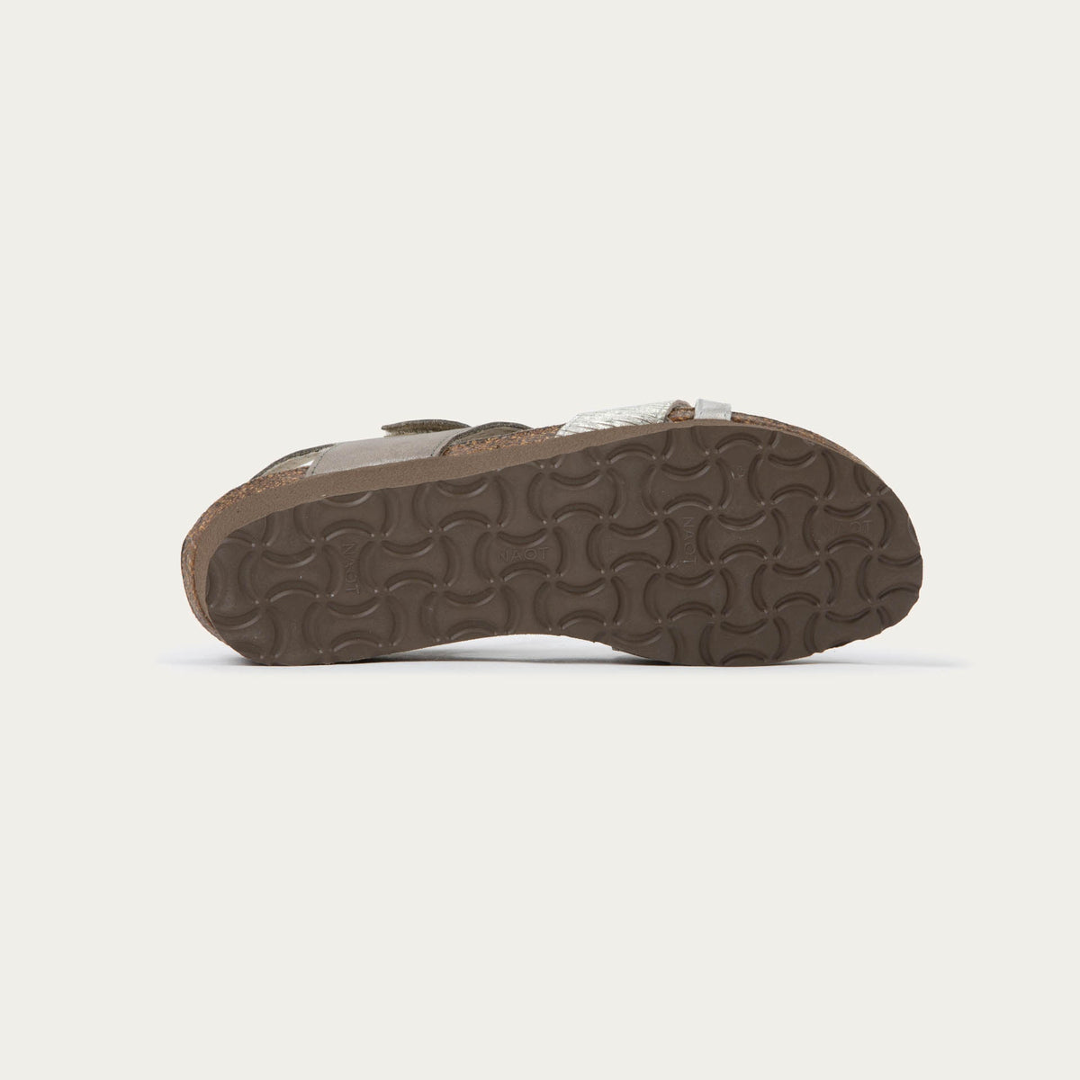 Bottom view of a gray open-toe sandal with a cork wedge sole. Features leather and suede straps crossing over the front and a back strap with Velcro closure. 