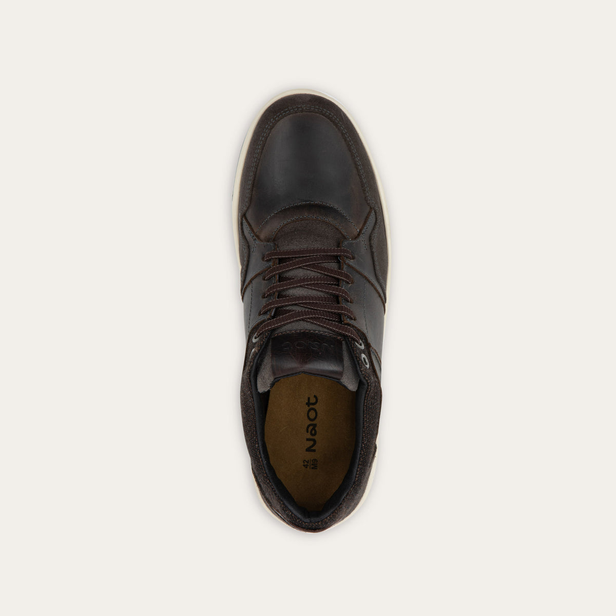 Top view of a gray sneaker with brown accents on a white sole.