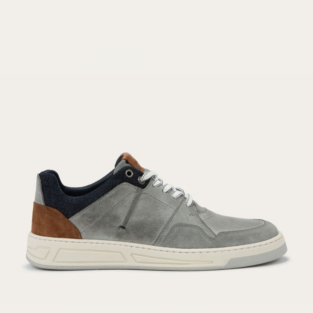Gray sneaker with brown accents on a light gray background