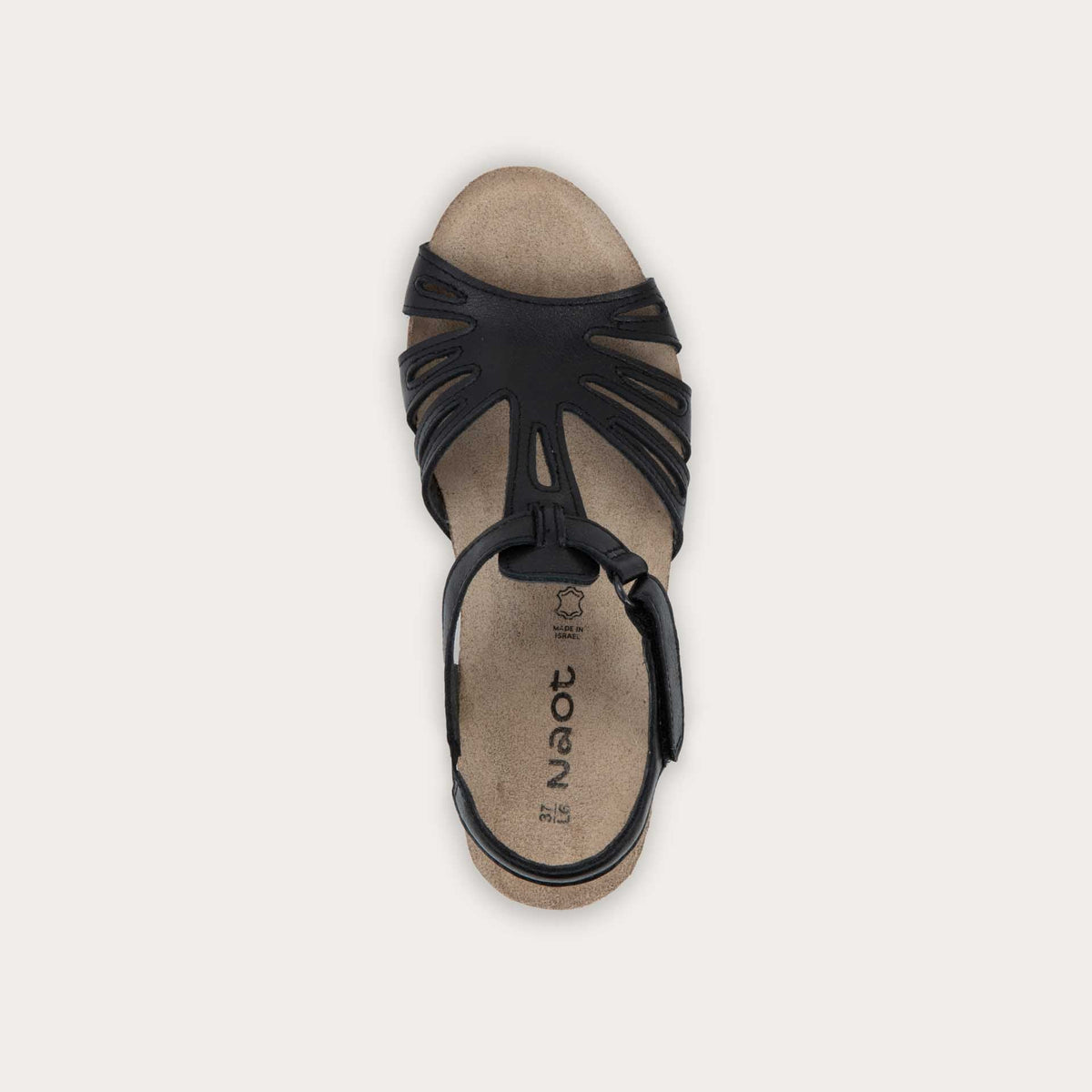 Top view of a  black wedge sandal with strappy design, open toe, and adjustable ankle strap on a cork footbed.