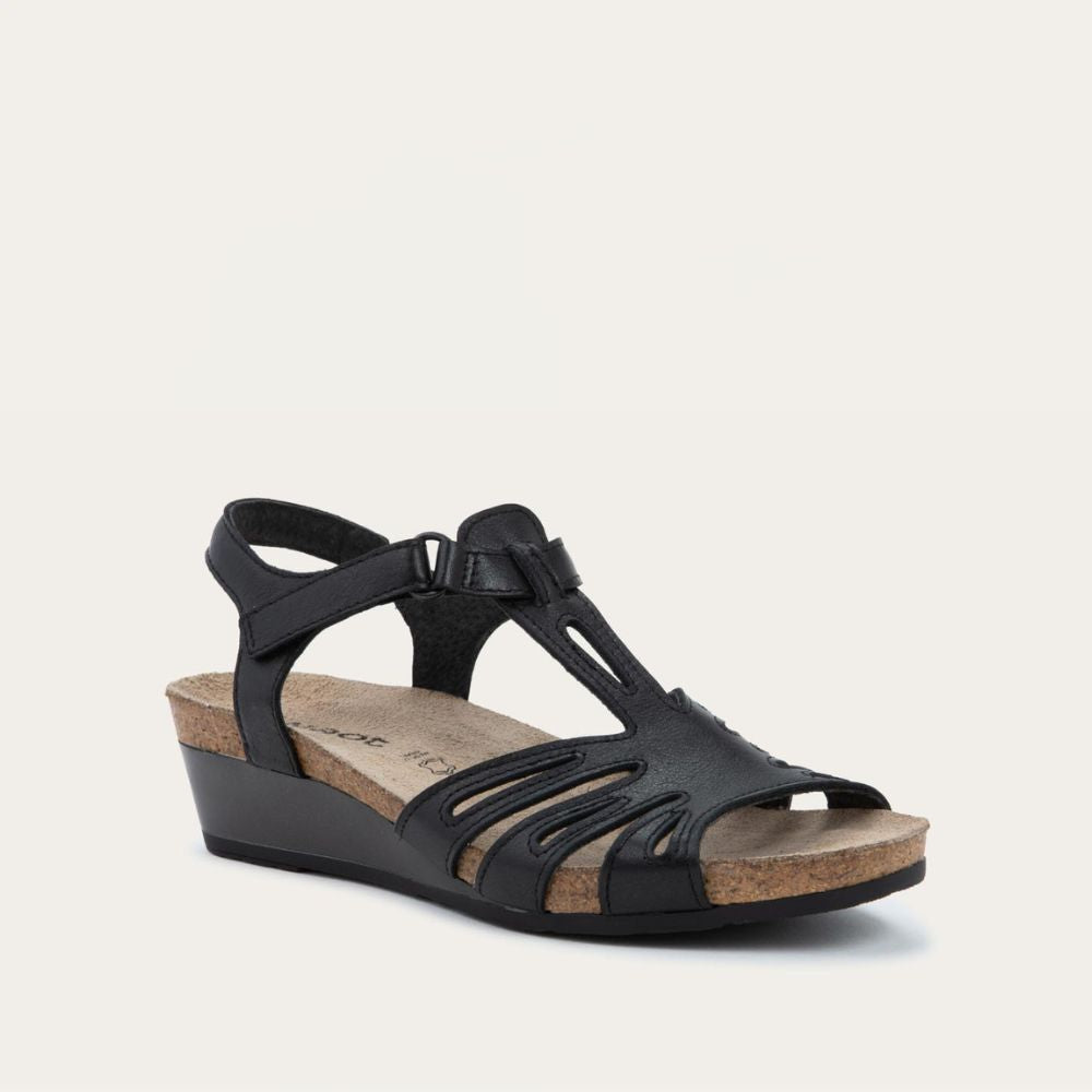 Angled profile view of a  black wedge sandal with strappy design, open toe, and adjustable ankle strap on a cork footbed.