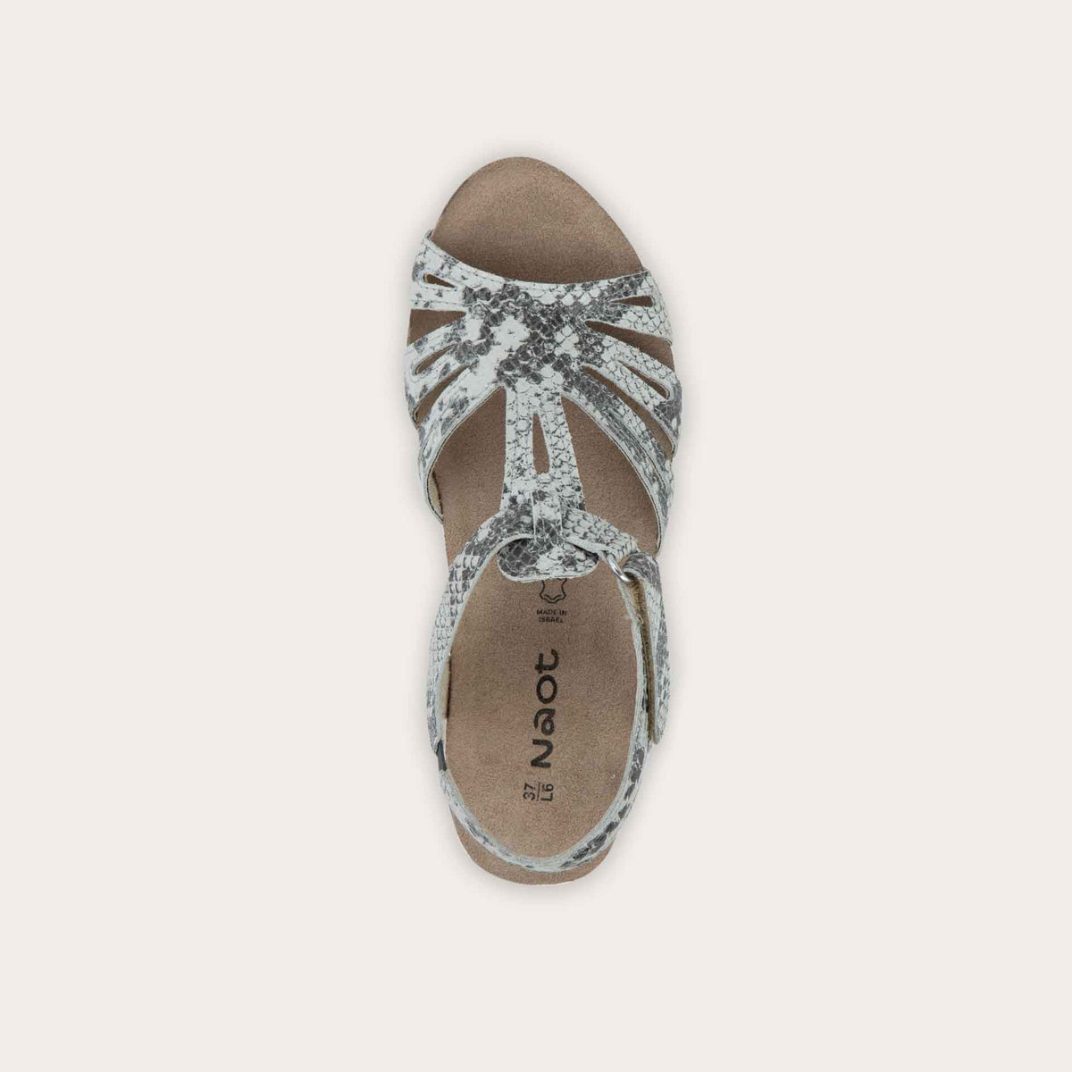 Top view of a  black wedge sandal with strappy design, open toe, and adjustable ankle strap on a cork footbed.
