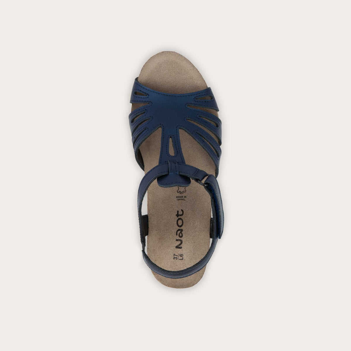 Top view of a  black wedge sandal with strappy design, open toe, and adjustable ankle strap on a cork footbed.