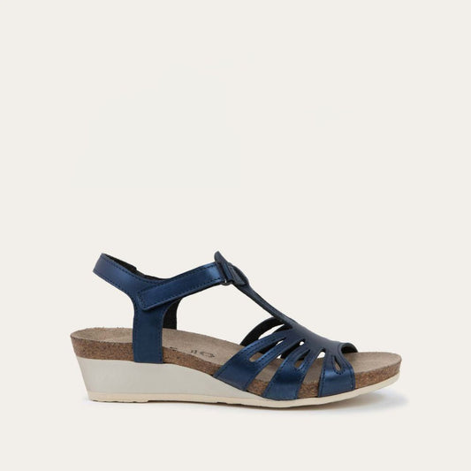 Profile view of a  black wedge sandal with strappy design, open toe, and adjustable ankle strap on a cork footbed.
