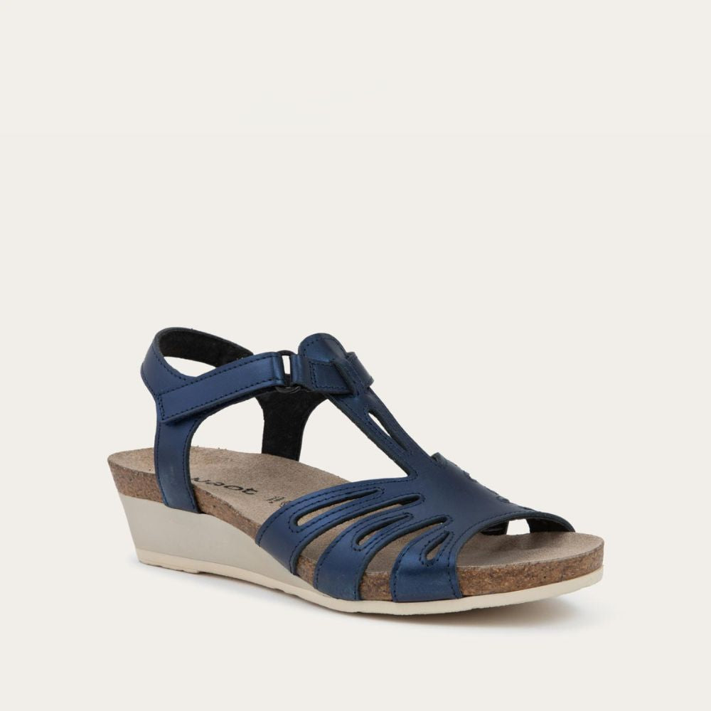 Angled profile view of a  black wedge sandal with strappy design, open toe, and adjustable ankle strap on a cork footbed.