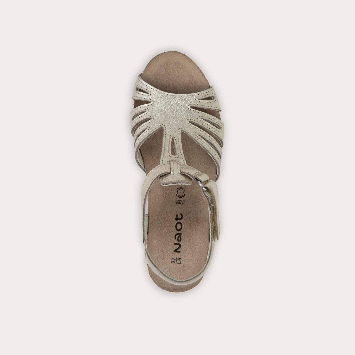 Bottom view of a gold wedge sandal with strappy design, open toe, and adjustable ankle strap on a cork footbed.