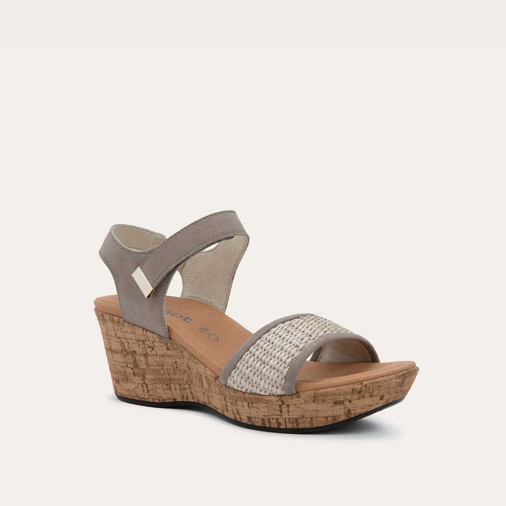 Angled profile view of a wedge heeled sandal with a gray leather ankle strap, and woven beige front strap