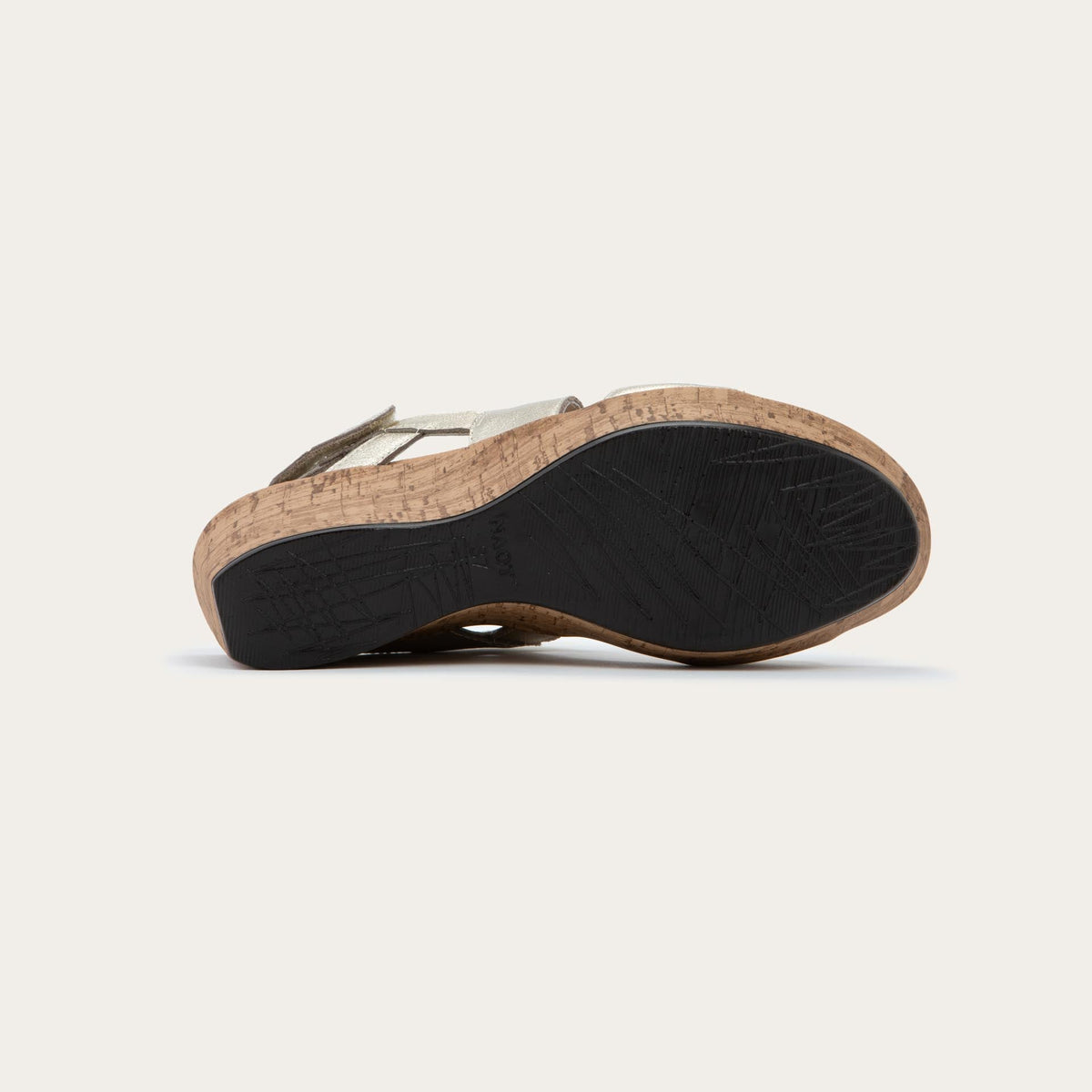 Bottom view of a gold sandal with metallic straps on a cork wedge sole. Features an open toe and wedge heel.