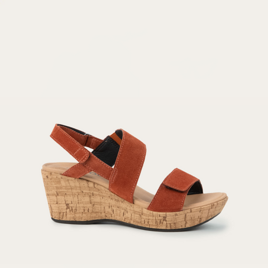A brown strappy wedge sandal with a cork sole and smooth leather upper.