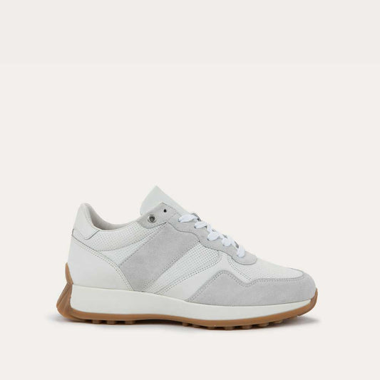 Profile view of a multi-material white lace up sneaker.