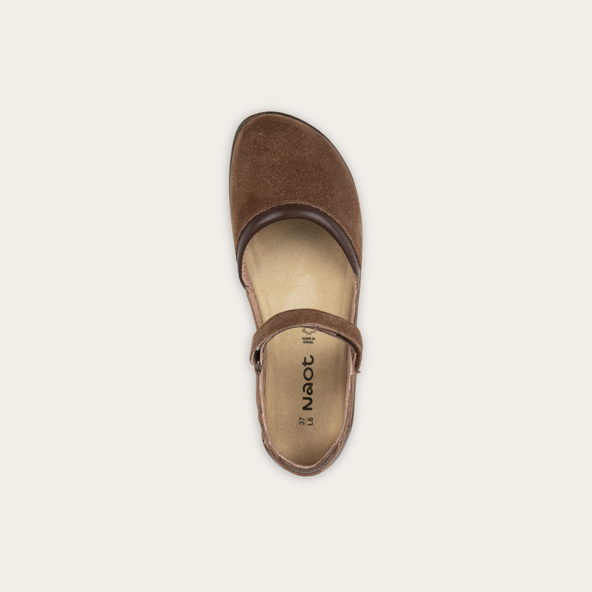 Top view of a brown Mary Jane featuring contrasting materials and cutouts by the heel on a dark sole.