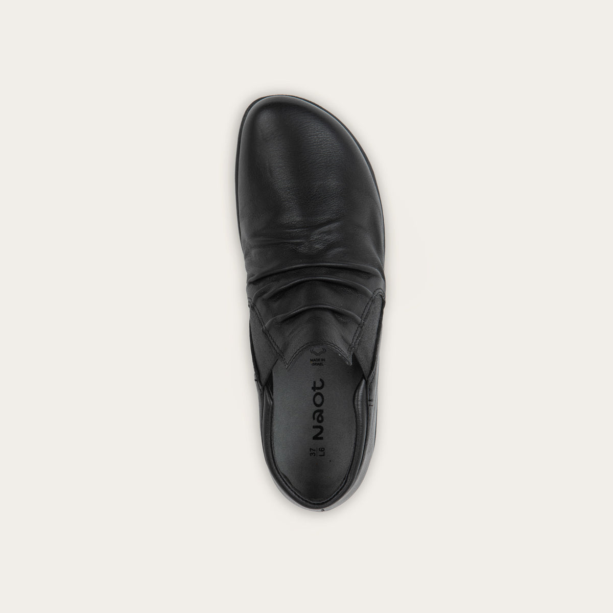 Top view of a black leather ankle boot with a textured sole.