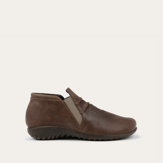 Side view of a brown leather ankle boot with a textured sole.