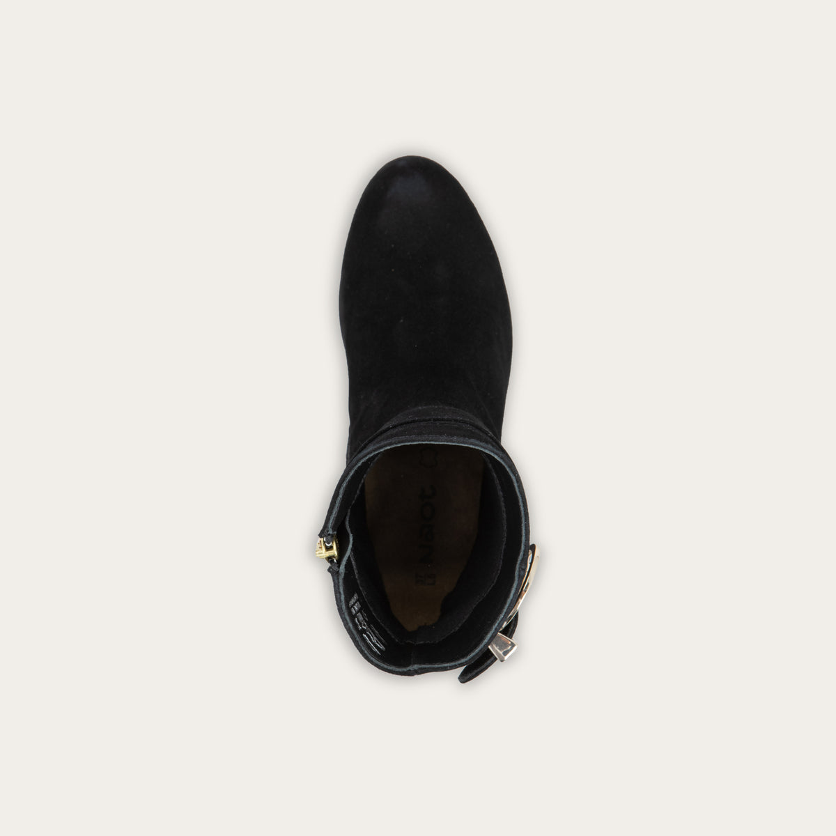 Top view of a black suede ankle boot featuring a low block heel and a decorative gold-toned buckle strap around the ankle.