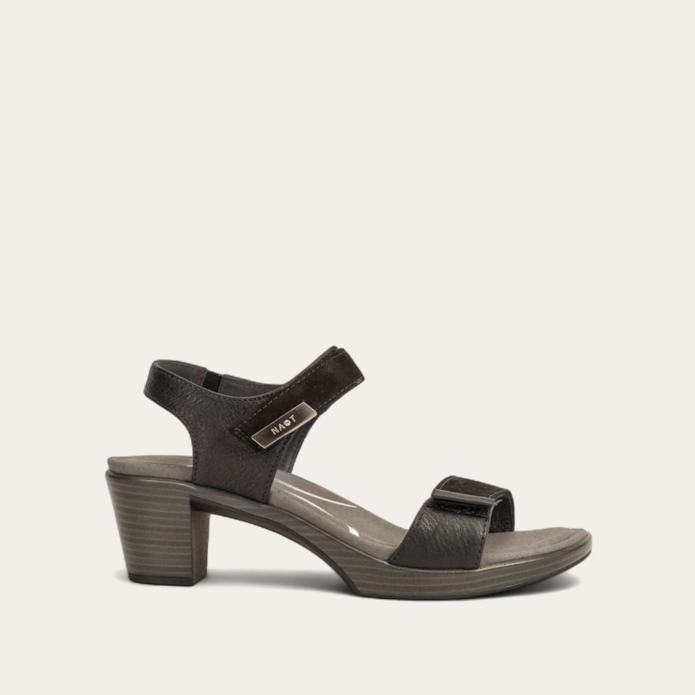 A black sandal with double hook and loop straps and a low heel, on a white background.