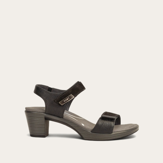 A black sandal with double hook and loop straps and a low heel, on a white background.