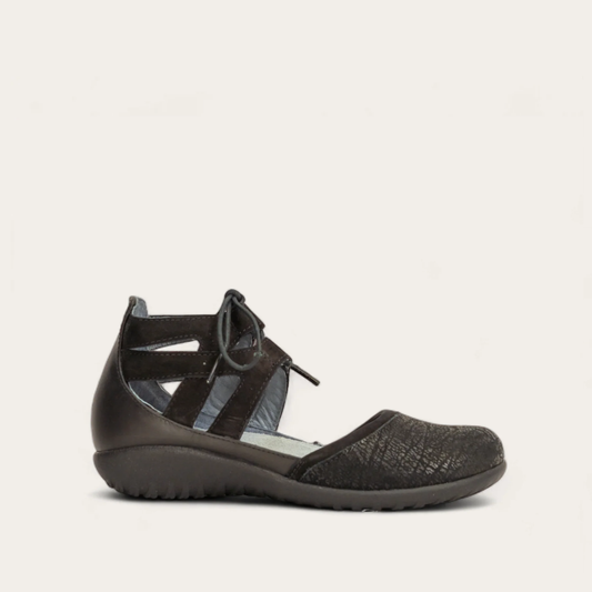 A black flat sandal with ankle strap and textured upper from the brand Naot.
