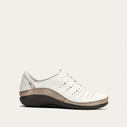 A white, lace-up, low-top women's shoe with a slight heel and metallic detailing.